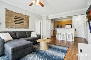 a living room with a couch and a table at Extremely Comfortable King Beds in Super Cute Apt in Austin