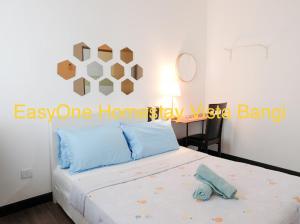 a bedroom with a bed with a sign on it at EZI homestay Vista Bangi in Kajang