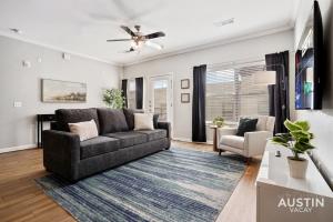 奥斯汀King Beds and Memory Foam Sleeper in Vibrant ATX Apt的带沙发和吊扇的客厅