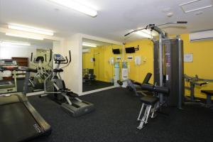 a gym with treadmills and machines in a room at Pandanas Apt 7 15th fl with harbour and city views in Darwin