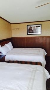 Ένα ή περισσότερα κρεβάτια σε δωμάτιο στο Grand Inn