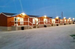 a row of houses with lights in a parking lot at Grand Inn in Big Lake