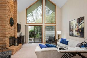 a living room with a couch and a fireplace at Fairway View Retreat in Eugene