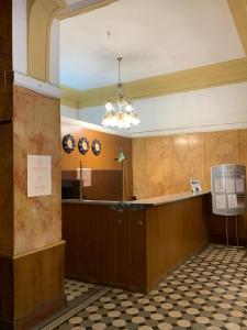 a waiting area in a building with clocks on the wall at Готель Пасаж in Odesa