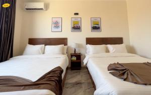 Ένα ή περισσότερα κρεβάτια σε δωμάτιο στο Happy View Inn