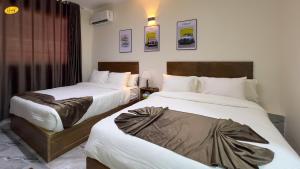Ένα ή περισσότερα κρεβάτια σε δωμάτιο στο Happy View Inn