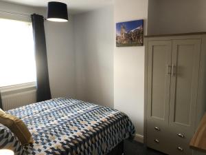 a bedroom with a bed and a window at Hattie's Cottage in Lincoln