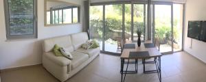 a living room with a couch and a table at Acacia Hill apartments B3 in Herceg-Novi