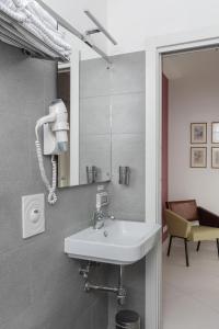 een badkamer met een wastafel en een spiegel bij Petrucci Garden by Enjoy Napoli in Napels