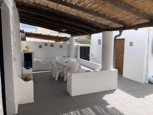 a kitchen and dining room with a table and chairs at Casa Cristian Stromboli in Stromboli +4 photos