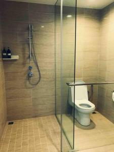 a bathroom with a toilet and a glass shower stall at 5 Stars Seafront Suite By The Sea 日落无敌全海景 5星 酒店等级 in Batu Ferringhi