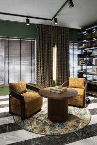 a living room with two chairs and a table at Radisson Collection Hotel, Santa Sofia Milan in Milan