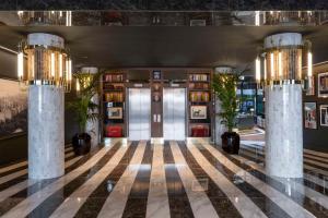 a lobby with two columns and a door at Radisson Collection Hotel, Santa Sofia Milan in Milan +73 photos