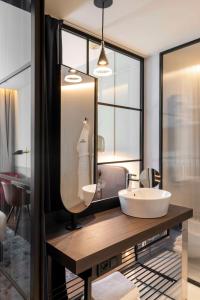 a bathroom with a sink and a mirror at Radisson Collection Hotel, Santa Sofia Milan in Milan