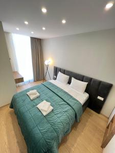 Postel nebo postele na pokoji v ubytování Aparthotel Holiday Lux Batumi