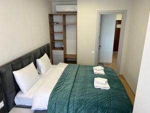 Postel nebo postele na pokoji v ubytování Aparthotel Holiday Lux Batumi