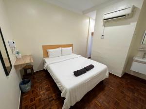 Postel nebo postele na pokoji v ubytování Homestay Suria