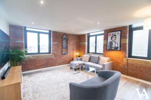 a living room with a brick wall at Velvet Apartments - Conditioning House in Bradford