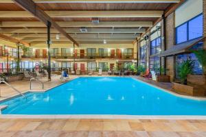 a large swimming pool in a large building at Wyndham Garden York in York