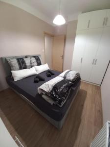 a bedroom with a large bed with pillows on it at Kassandrou Deluxe Apartment in Thessaloniki