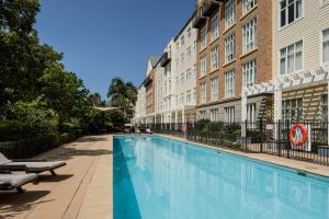 a swimming pool in front of a building at Rydges Newcastle in Newcastle