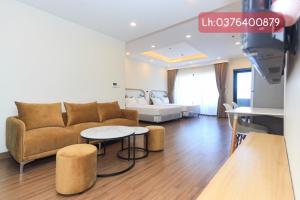 a living room with a couch and a table at FLC Sea Tower Qui Nhơn Apartment - Căn Hộ Sea View in Quy Nhon