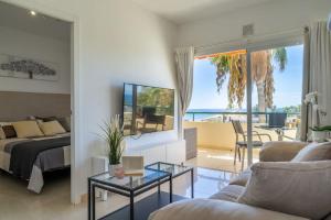 a living room with a bed and a view of the ocean at Apartment in front of the ocean in Los Cristianos