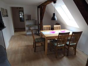 a dining room table and chairs in a room at LANDHAUS LAAVE FERIENWOHNUNG in Laave