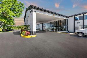 a building with a car parked in a parking lot at Days Inn by Wyndham Erie in Erie