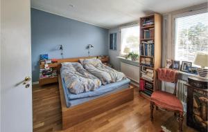 a bedroom with a bed and a book shelf at 2 Bedroom Beautiful Home In Göteborg in Gothenburg