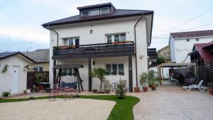 a house with a playground in front of it at Casa Sebastian in Costinesti