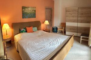 a bedroom with a large bed with orange walls at strandnahe FeWo mit Floß ( 24 h) und eigenem Kanu in Mirow