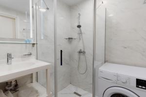 a bathroom with a shower and a washing machine at Batumi Beach Friends4Friends in Batumi +100 photos