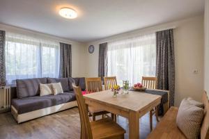 a living room with a couch and a table at Bauernhof Nagelschmiedhof in Langkampfen