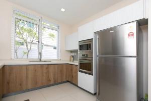 een keuken met een roestvrijstalen koelkast en een raam bij GeorgeTown PrivatePool Snooker 25Pax BBQ in George Town