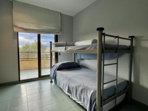 a bedroom with two bunk beds and a window at La Pineda I 1 3-6 in L'Estartit