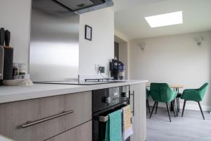 a kitchen with a sink and a stove top oven at Wave Stays - Ground Floor Apartment in Cleveleys