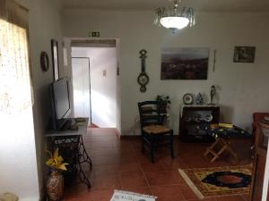 a living room with a flat screen tv and a room at AL Miradouro do Outeiro in Guarda