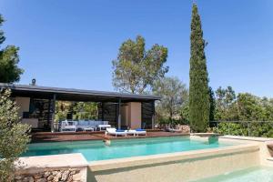 a swimming pool in front of a house at Premier Villa Rental in Mallorca Es Barranc Vell in Pòrtol