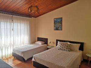 a bedroom with two beds and a window at ''O Veleiro'' Rest. Resid. in Torreira