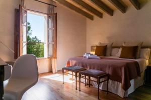 a bedroom with a bed with two chairs and a window at Premier Villa Rental in Mallorca Es Barranc Vell in Pòrtol +42 photos