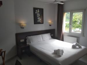 a bedroom with a bed with two teddy bears on it at Insitu Eurotel Andorra in Andorra la Vella