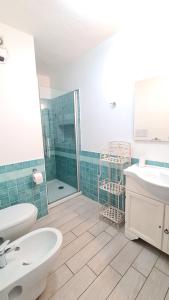 a bathroom with two sinks and a shower at Appartamento- La Casa del Mirto- Porto Rotondo in Porto Rotondo +14 photos