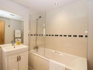a bathroom with a shower and a sink and a tub at Manor Farm Lodge in Salisbury +22 photos
