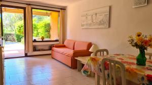 a living room with a couch and a table at Appartamento- La Casa del Mirto- Porto Rotondo in Porto Rotondo