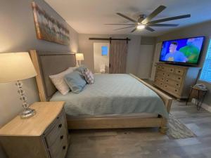 a bedroom with a bed and a flat screen tv at 3 bedroom 2 bath with hot tub, game room and boat slip in Crystal River