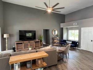 a living room with a couch and a flat screen tv at Spacious 4 bedroom with 2 baths with Pool and boat dock in Crystal River
