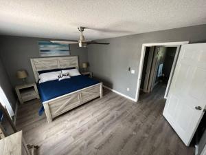 a bedroom with a bed and a ceiling fan at Spacious 4 bedroom with 2 baths with Pool and boat dock in Crystal River