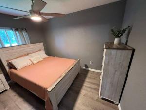 a bedroom with a bed and a ceiling fan at Spacious 4 bedroom with 2 baths with Pool and boat dock in Crystal River