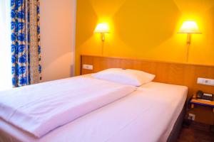 Posteľ alebo postele v izbe v ubytovaní Hotel Strohofer